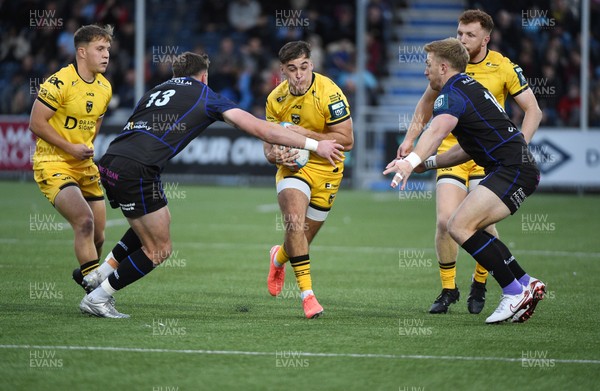 111025 - Glasgow Warriors v Dragons RFC - United Rugby Championship - Harri Ackerman of Dragons tackled by Ollie Smith of Glasgow Warriors and Kyle Steyn of Glasgow Warriors
