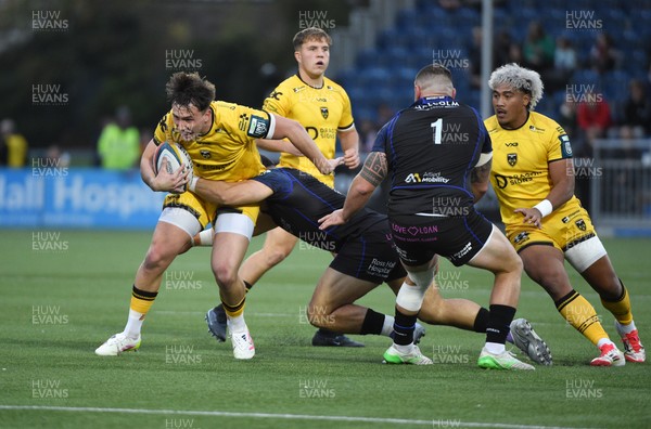 111025 - Glasgow Warriors v Dragons RFC - United Rugby Championship - Harri Ackerman of Dragons tackled by Sione Tuipulotu of Glasgow Warriors