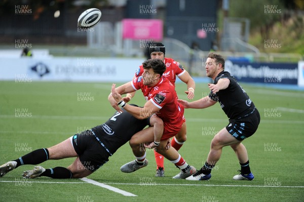 111020 - Glasgow Warriors v Scarlets - Guinness PRO14 - Johnny Williams of Scarlets is tackled by Fraser Brown