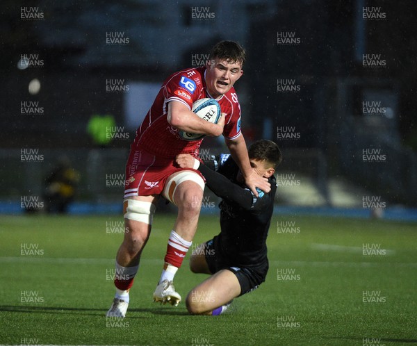 140423 - Glasgow Warriors v Scarlets - United Rugby Championship - Josh Macleod of Scarlets hands off Tom Jordan of Glasgow