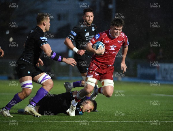 140423 - Glasgow Warriors v Scarlets - United Rugby Championship - Josh Macleod of Scarlets is tackled by Tom Jordan of Glasgow