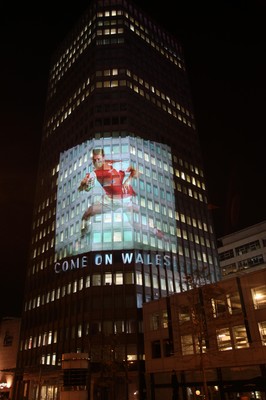 14.10.11 -  Good luck messages are projected onto the side Admiral's offices in Cardiff ahead of Wales' Rugby World Cup Semi Final against France 