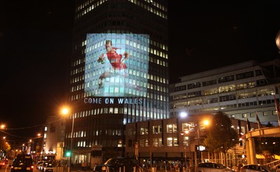14.10.11 -  Good luck messages are projected onto the side Admiral's offices in Cardiff ahead of Wales' Rugby World Cup Semi Final against France 