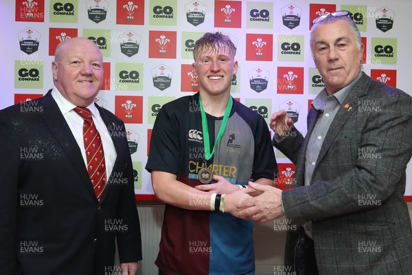 290324 - Gowerton v Cardiff Quins - WRU Boys U18 Bowl Final -  Kevin Lewis and Geraint John of the WRU present Quins Lloyd Lucas with his Man of The Match medal