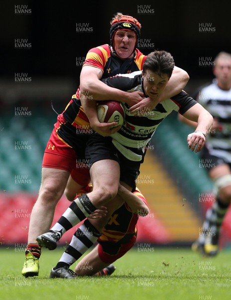 230416 - WRU - Plate Final - Gowerton Youth v Brynmawr Youth - Callum Carsen of Gowerton is tackled by Ellis Price and Matthew Jarrett of Brynmawr