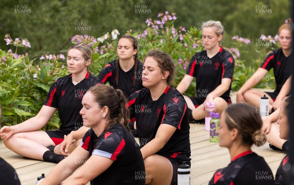 150722 - Wales Women’s rugby squad training session at The Green Mile, Cardiff - Members of the Wales Women’s team practice breathing control and relaxation after taking part in the challenge