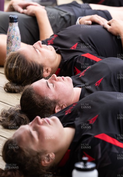 150722 - Wales Women’s rugby squad training session at The Green Mile, Cardiff - Members of the Wales Women’s team practice breathing control and relaxation after taking part in the challenge