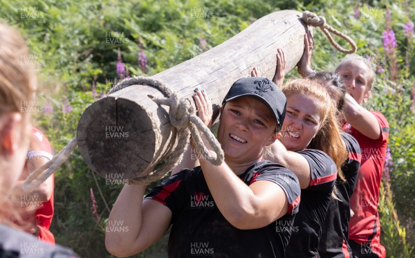 150722 - Wales Women’s rugby squad training session at The Green Mile, Cardiff - Alisha Butchers completes the log lift with team mates on the Green Mile course in the woods near Cardiff 