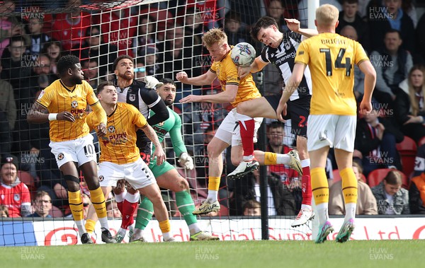 060424 - Grimsby Town v Newport County - Sky Bet League 2 - Will Evans of Newport County removes threat from Doug Tharme of Grimsby Town