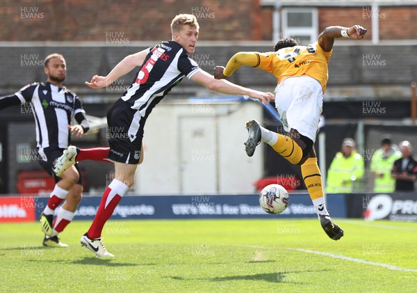 060424 - Grimsby Town v Newport County - Sky Bet League 2 - Offrande Zanzala of Newport County tries to gain control of the ball but is blocked by Harvey Rodgers of Grimsby Town