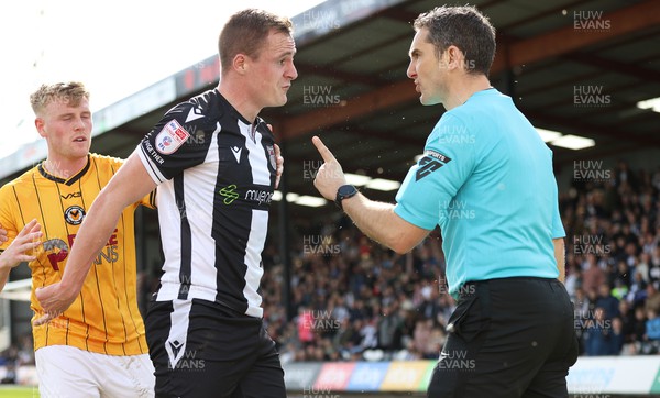 060424 - Grimsby Town v Newport County - Sky Bet League 2 - Keiran Green of Grimsby Town is shown yellow card by referee Robert Madley for ruck with Harry Charsley of Newport County