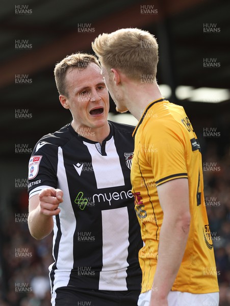 060424 - Grimsby Town v Newport County - Sky Bet League 2 - Keiran Green of Grimsby Town is shown yellow card by referee Robert Madley for ruck with Harry Charsley of Newport County