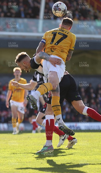 060424 - Grimsby Town v Newport County - Sky Bet League 2 - Bryn Morris of Newport County is obstructed by Gavan Holohan of Grimsby Town as he heads the ball towards goal