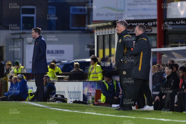 091119 - Grimsby Town v Newport County - FA Cup First Round -  Grimsby manager Michael Jolley and Newport manager Michael Flynn in the dug outs during the 2nd half