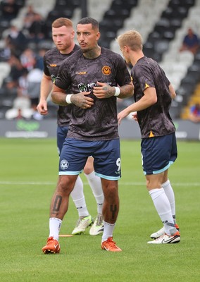 160825 - Grimsby Town v Newport County - Sky Bet League 2 - Courtney Baker-Richardson of Newport and Lee Jenkins of Newport and Matthew Smith of Newport warm up before the match