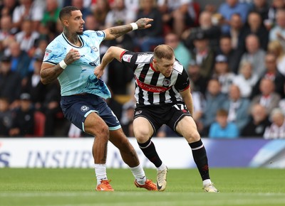 160825 - Grimsby Town v Newport County - Sky Bet League 2 - Courtney Baker-Richardson of Newport is held by Cameron McJannet of Grimsby Town