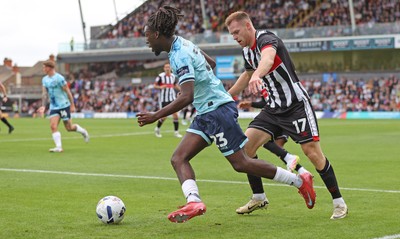 160825 - Grimsby Town v Newport County - Sky Bet League 2 - Michael Reindorf of Newport followed by Cameron McJannet of Grimsby Town