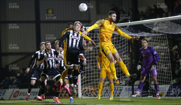 250220 - Grimsby Town v Newport County - Sky Bet League 2 - Ryan Inniss of Newport County rises to meet a corner