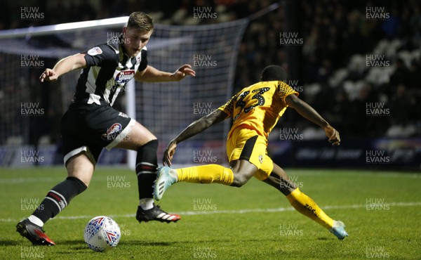 250220 - Grimsby Town v Newport County - Sky Bet League 2 - Jordan Green of Newport County is chased by Mattie Pollock of Grimsby Town