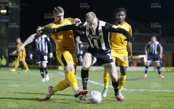 250220 - Grimsby Town v Newport County - Sky Bet League 2 - Scot Bennett of Newport County tries to take the ball off Elliott Whitehouse of Grimsby Town
