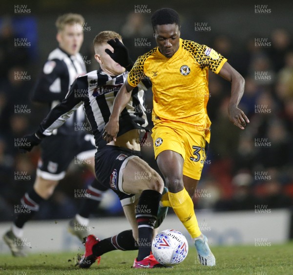 250220 - Grimsby Town v Newport County - Sky Bet League 2 - Jordan Green of Newport County and Elliott Whitehouse of Grimsby Town