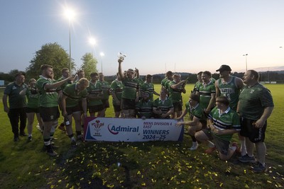 300425 - Gwernyfed RFC League Trophy Presentation - Admiral National League 4 West B - Gwernyfed RFC Captain Sam Stevens celebrates lifting the trophy with his team