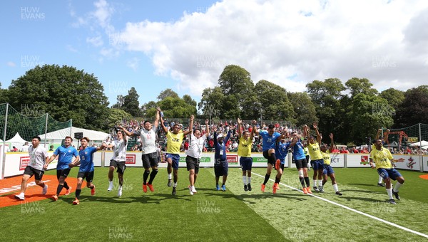280719 - Homeless World Cup, Cardiff - Brazil and Hong Kong celebrate at the end of their match on the second day of the Homeless World Cup, held in Bute Park, Cardiff