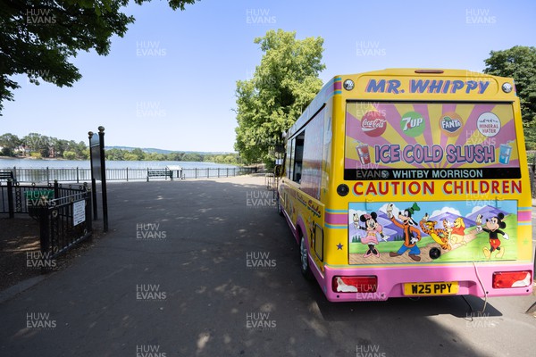 180722 - An ice cream van waits for customers at a virtually deserted Roath Park Lake in Cardiff as people appear to heed the Amber Warning for extreme heat and avoid the sun in the early afternoon