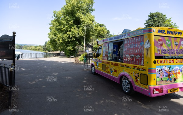 180722 - An ice cream van waits for customers at a virtually deserted Roath Park Lake in Cardiff as people appear to heed the Amber Warning for extreme heat and avoid the sun in the early afternoon