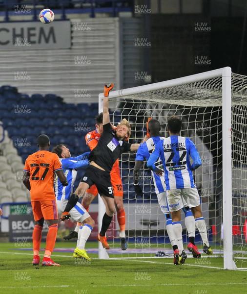 050321 - Huddersfield Town v Cardiff City - Sky Bet Championship - Goalkeeper Ryan Scholfield of Huddersfield and Kieffer Moore of Cardiff in the goal mouth reach for the corner cross 