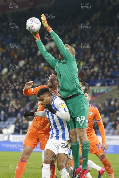 120220 - Huddersfield Town v Cardiff City - Sky Bet Championship - Jonas Lossi of Huddersfield saves from Sean Morrison of Cardiff with the help from Steve Mounie of Huddersfield 