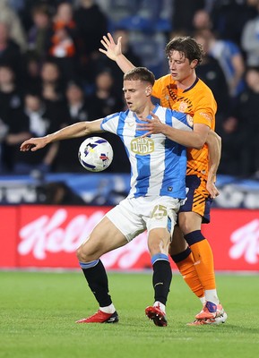 140426 - Huddersfield Town v Cardiff City - Sky Bet League 1 - Will Fish of Cardiff and Dion Charles of Huddersfield
