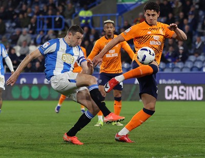 140426 - Huddersfield Town v Cardiff City - Sky Bet League 1 - Yousef Saleh of Cardiff skies the ball through defence by Murray Wallace of Huddersfield
