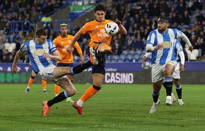140426 - Huddersfield Town v Cardiff City - Sky Bet League 1 - Yousef Saleh of Cardiff skies the ball through defence by Murray Wallace of Huddersfield