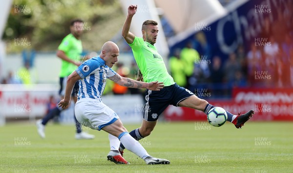 250818 - Huddersfield Town v Cardiff City - Premier League - Aaron Mooy of Huddersfield Town is challenged by Joe Ralls of Cardiff City