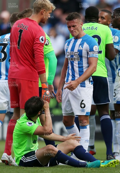 250818 - Huddersfield Town v Cardiff City - Premier League - Jonathan Hogg of Huddersfield Town who receives a red card talks to Harry Arter of Cardiff City