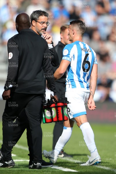 250818 - Huddersfield Town v Cardiff City - Premier League - Jonathan Hogg of Huddersfield Town walks past Huddersfield Town Manager David Wagner after receiving a red card