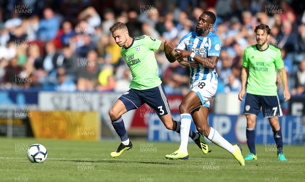 250818 - Huddersfield Town v Cardiff City - Premier League - Joe Bennett of Cardiff City is challenged by Isaac Mbenza of Huddersfield Town