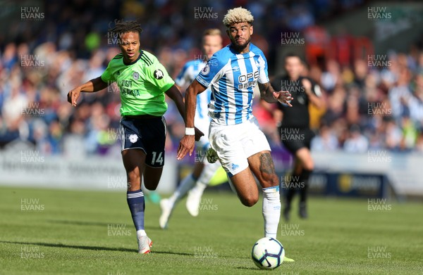 250818 - Huddersfield Town v Cardiff City - Premier League - Philip Billing of Huddersfield Town is challenged by Bobby Reid of Cardiff City