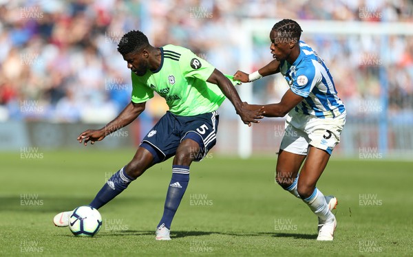 250818 - Huddersfield Town v Cardiff City - Premier League - Bruno Ecuele Manga of Cardiff City is challenged by Terence Kongolo of Huddersfield Town