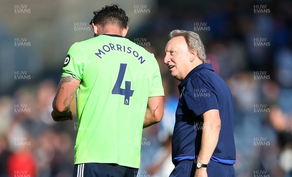 250818 - Huddersfield Town v Cardiff City - Premier League - Cardiff Manager Neil Warnock talks to Sean Morrison of Cardiff City