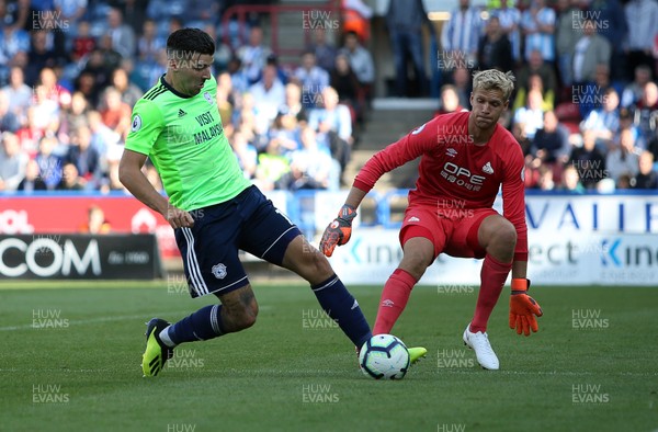 250818 - Huddersfield Town v Cardiff City - Premier League - Callum Paterson of Cardiff City gets the ball away from Jonas Lossl of Huddersfield Town