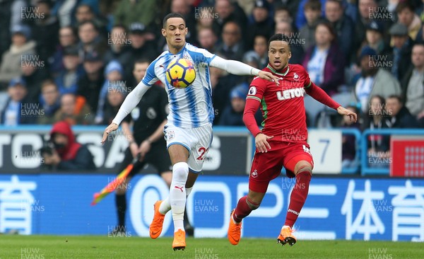 100318 - Huddersfield Town v Swansea City - Premier League - Thomas Ince of Huddersfield is challenged by Martin Olsson of Swansea