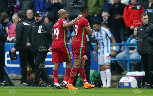 100318 - Huddersfield Town v Swansea City - Premier League - Jordan Ayew of Swansea is walked off the pitch by brother Andre Ayew after being given a red card