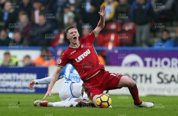 100318 - Huddersfield Town v Swansea City - Premier League - Sam Clucas of Swansea is tackled by Collin Quaner of Huddersfield