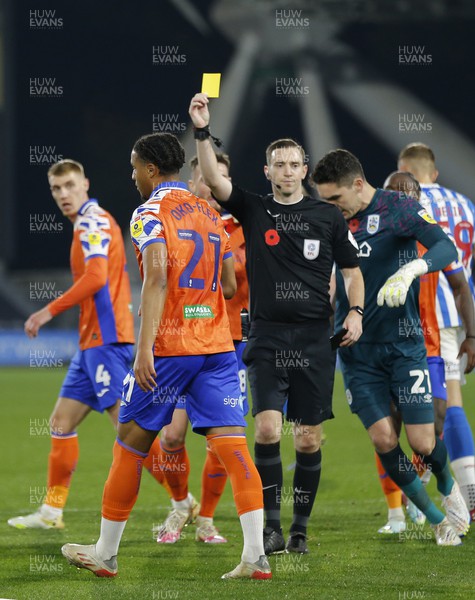 121122 - Huddersfield Town v Swansea City - Sky Bet Championship - Armstrong Oko-Flex  of Swansea is shown the yellow card by referee Ben Toner