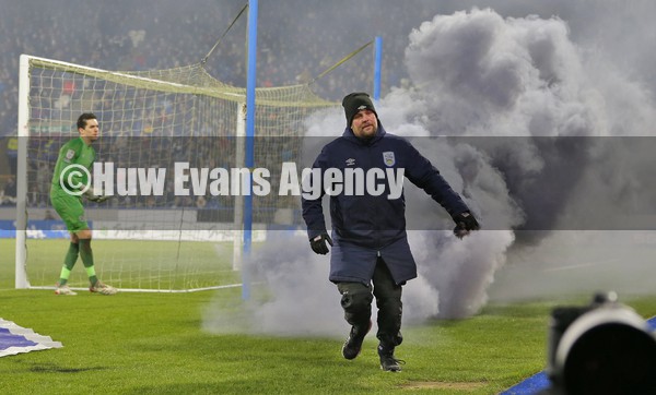 150122 - Huddersfield Town v Swansea City - Sky Bet Championship - the fire steward takes a flare off the pitch thrown by Swansea fans