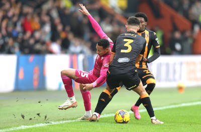 100224 - Hull City v Swansea City - Sky Bet Championship - Ronald of Swansea is caught by Ryan Giles of Hull City and Jaden Philogene of Hull City