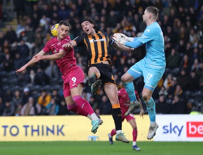 100224 - Hull City v Swansea City - Sky Bet Championship - Jerry Yates of Swansea and Jacob Greaves of Hull City leap for the ball with Ryan Allsop of Hull City