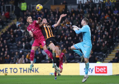 100224 - Hull City v Swansea City - Sky Bet Championship - Jerry Yates of Swansea and Jacob Greaves of Hull City leap for the ball